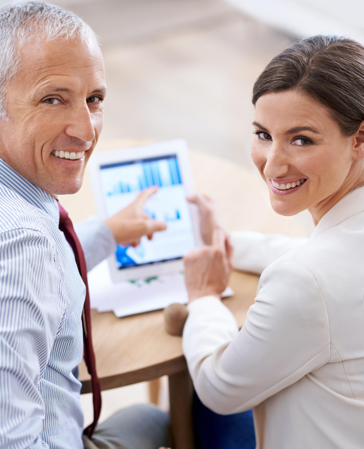 Employee Benefits Solutions - group of professionals at a table discussing benefits packages.