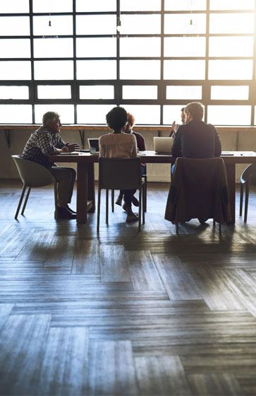 About Better Benefits Group - Team working at a table